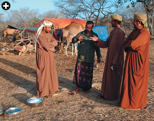 A Jabal Samhan Nature Reserve ranger talks to local residents in an effort to persuade them that the economic benefits of leopard preservation can outweigh the risks of livestock predation.